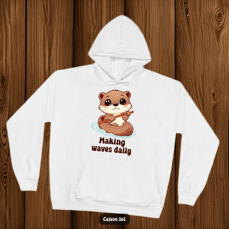 Funny otter playfully steering a canoe with a stick, eyes wide with wonder, a cozy hoodie for adventurers.