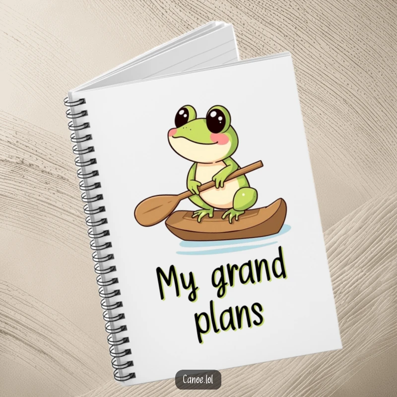Funny Notebook with a cheerful frog balancing on the end of a canoe paddle, perfect for notes.